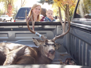 My wife and daughter in front of my first mule deer